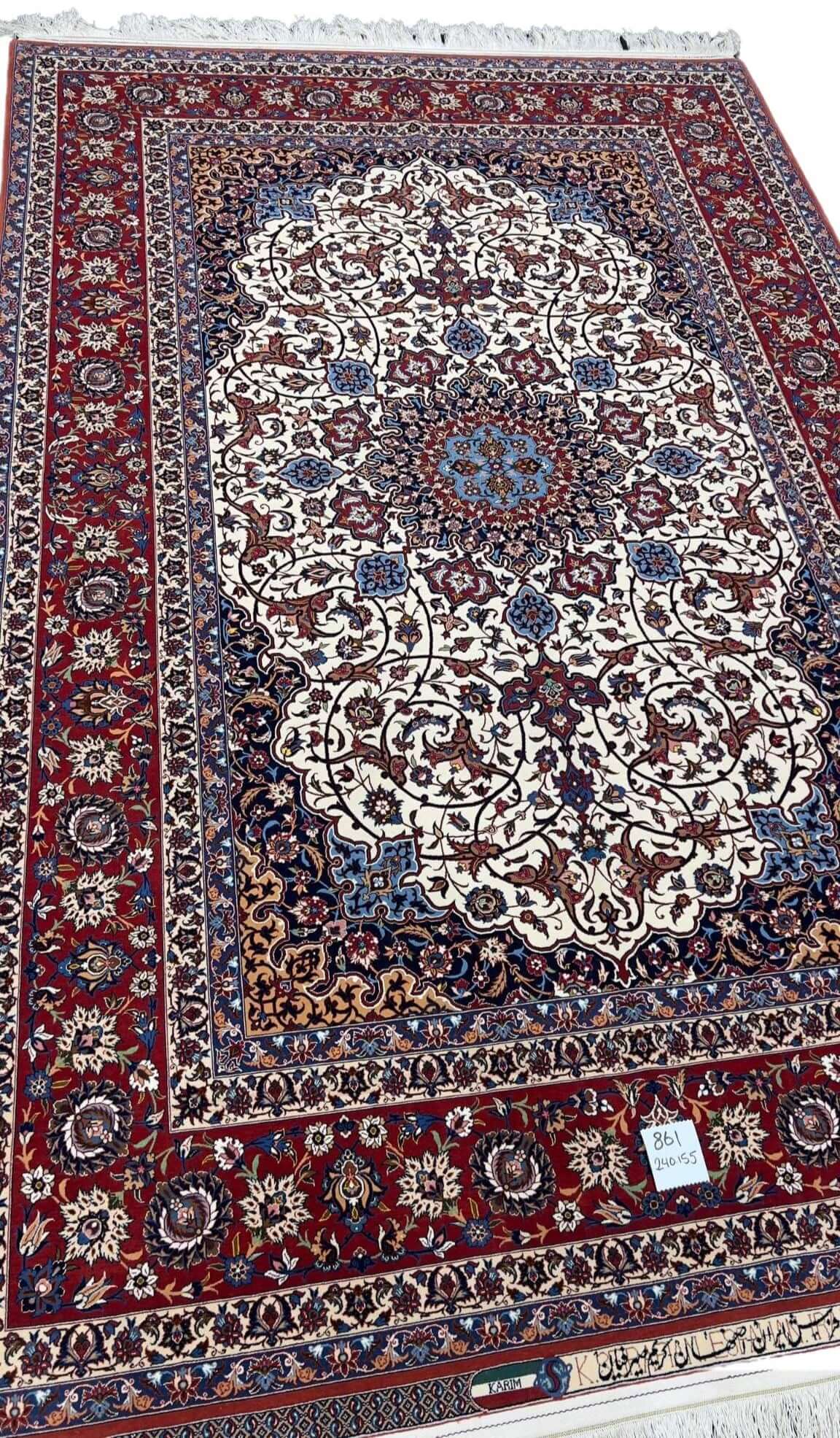 A detailed side view of the Genuine 5 x 7 Red and Beige Seirafian Persian rug, showcasing its intricate hand-knotted texture, luxurious wool and silk pile, and fine craftsmanship by Grand Master Karim Seirafian.